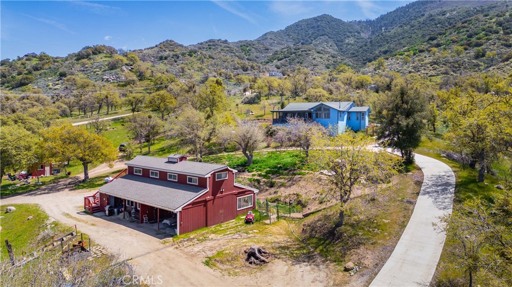 an aerial view of a house with a yard