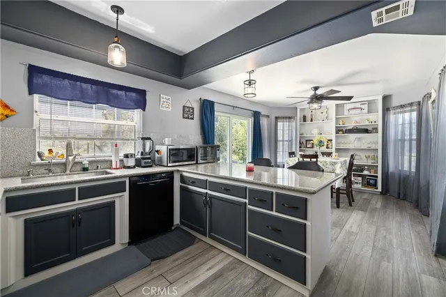 a kitchen with granite countertop a refrigerator and a sink
