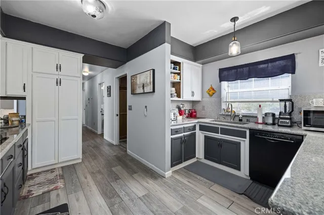 a kitchen with stainless steel appliances a stove refrigerator and cabinets