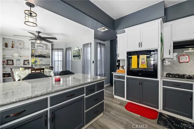 a kitchen with refrigerator and cabinets