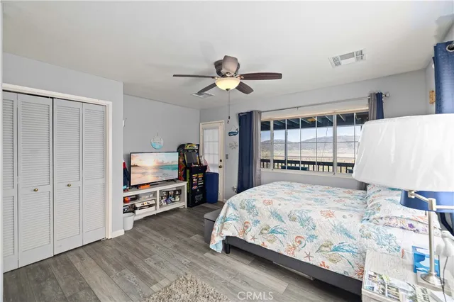 a bedroom with a bed a table and chair