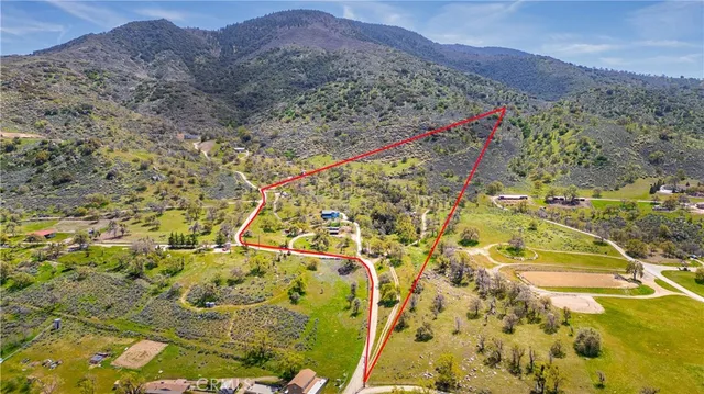 a view of a dry yard with mountains in the background