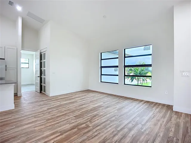 wooden floor in an empty room with a window