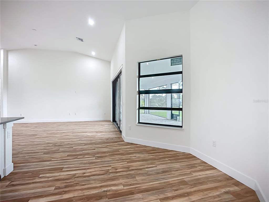 15 Heave Lane Placida, FL 33946 - Photo 22 of 70 a view of an empty room with a window and wooden floor