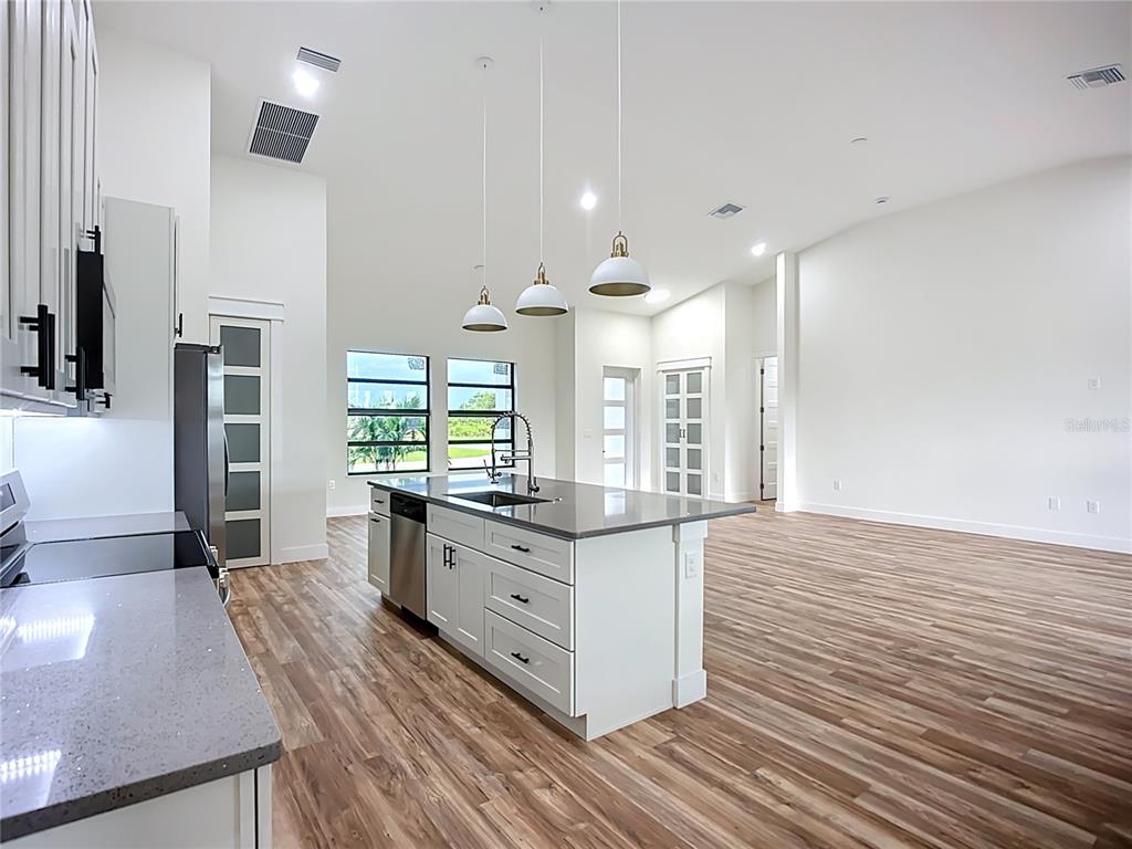 15 Heave Lane Placida, FL 33946 - Photo 23 of 70 a kitchen with stainless steel appliances granite countertop a stove and a wooden floors