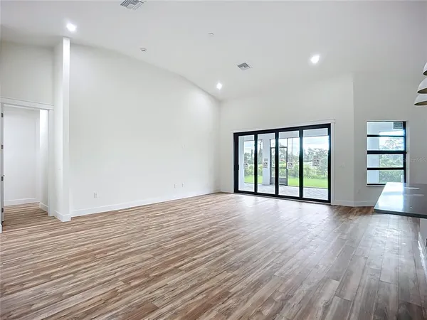 a view of a hallway with wooden floor and closet