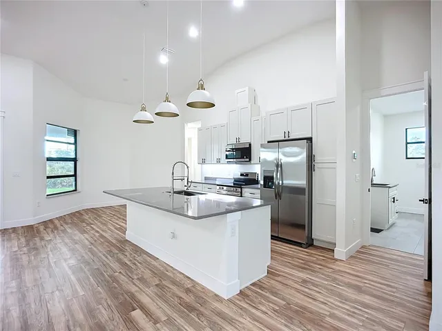 a bathroom with a granite countertop sink mirror and window