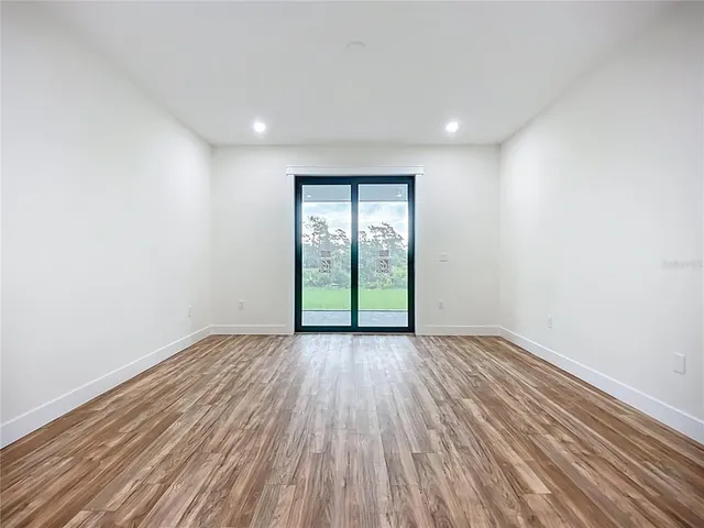 a bathroom with a granite countertop sink a bathtub and next to a window