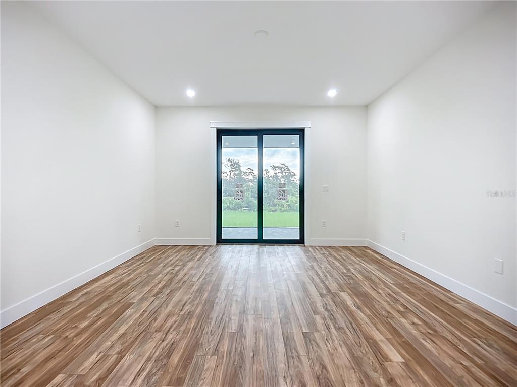 15 Heave Lane Placida, FL 33946 - Photo 31 of 70 a view of an empty room with wooden floor and a window