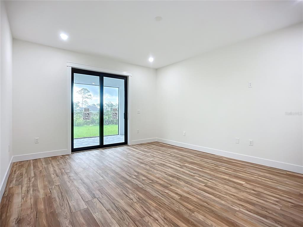 15 Heave Lane Placida, FL 33946 - Photo 32 of 70 a view of an empty room with wooden floor and a window