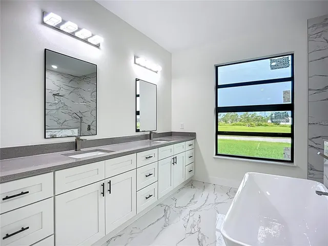 an empty room with wooden floor and a bathroom