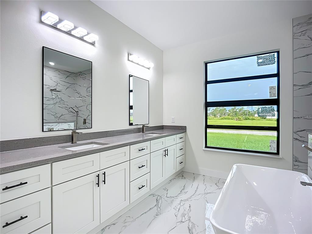 15 Heave Lane Placida, FL 33946 - Photo 37 of 70 a bathroom with a granite countertop sink mirror and window