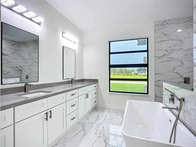 a bathroom with a granite countertop sink toilet a mirror and shower