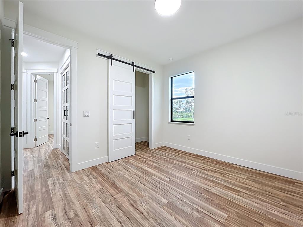 15 Heave Lane Placida, FL 33946 - Photo 46 of 70 an empty room with wooden floor closet and windows