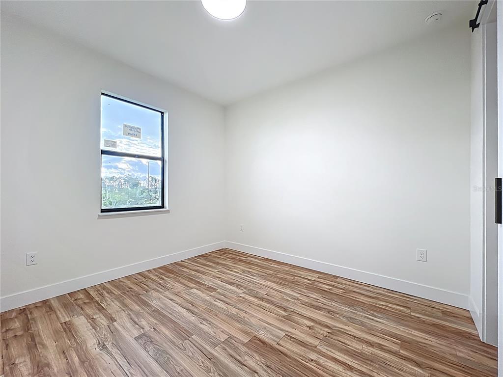 15 Heave Lane Placida, FL 33946 - Photo 47 of 70 a view of an empty room with wooden floor and a window