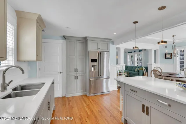 a kitchen with refrigerator and sink