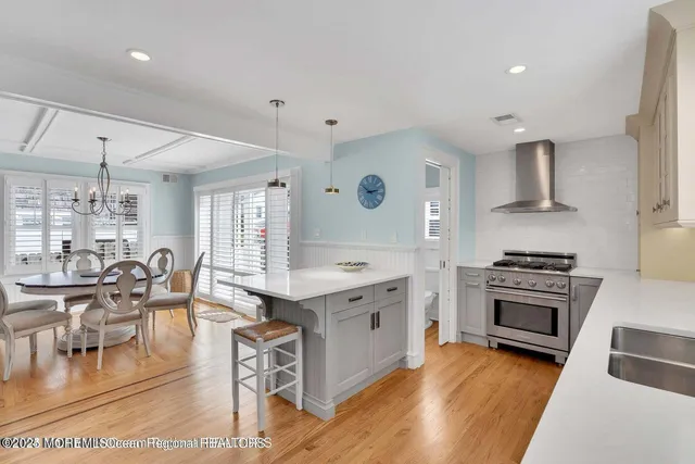 a kitchen with a stove a sink and a refrigerator