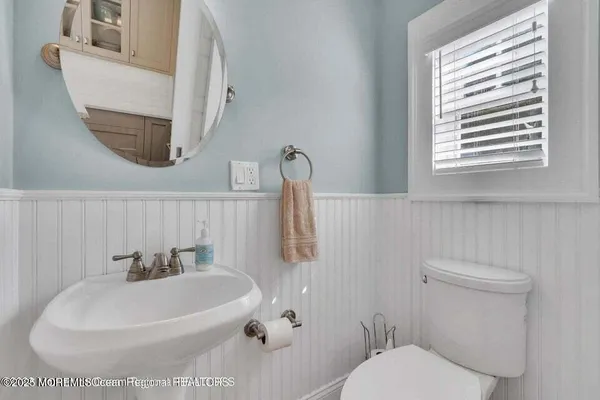 a white toilet sitting next to a bathroom sink