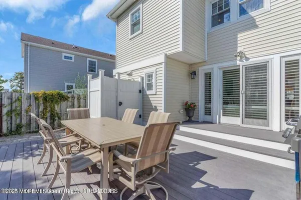 a view of a patio with table and chairs and potted plants