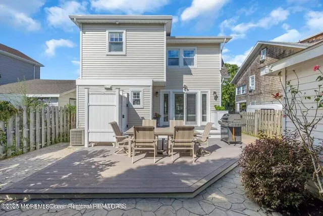 a view of a house with backyard porch and sitting area