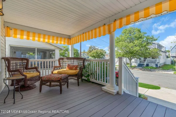 a balcony with furniture and wooden floor