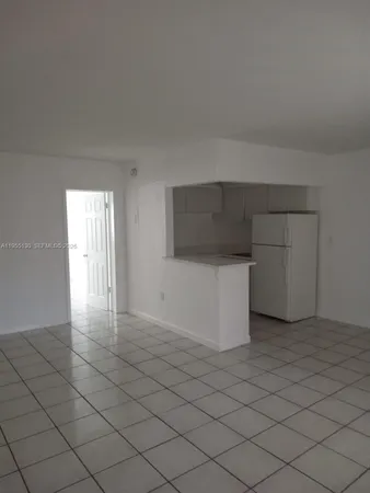 a view of an empty room and wooden floor