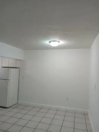 a kitchen with cabinets and white appliances