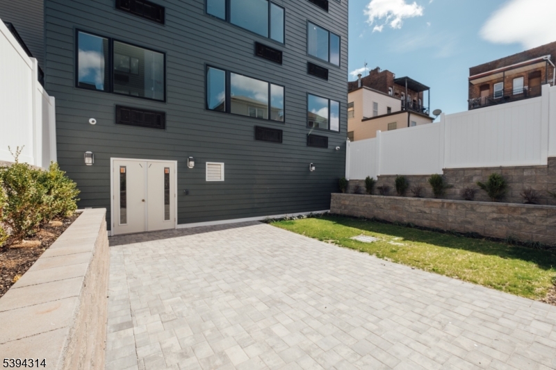 67 Summer Avenue, Unit 101 Newark, NJ 07104 - Photo 24 of 26 a front view of a house with a yard and garage