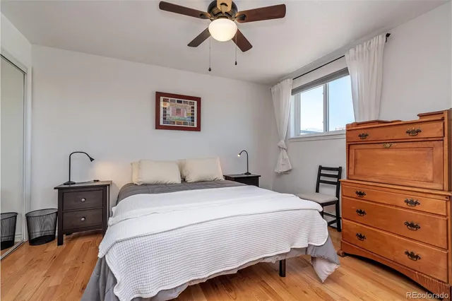 a bedroom with a bed and a tv on the dresser