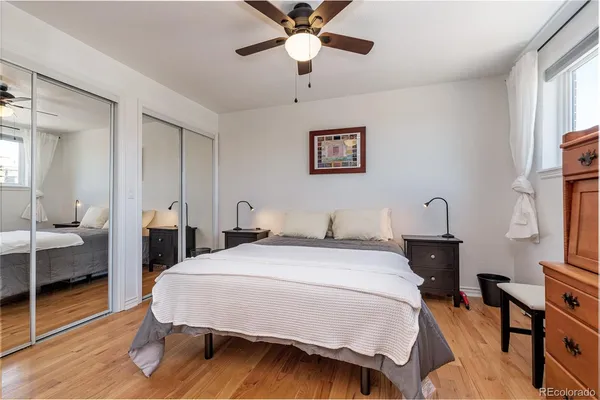 a spacious bedroom with a bed and a chandelier