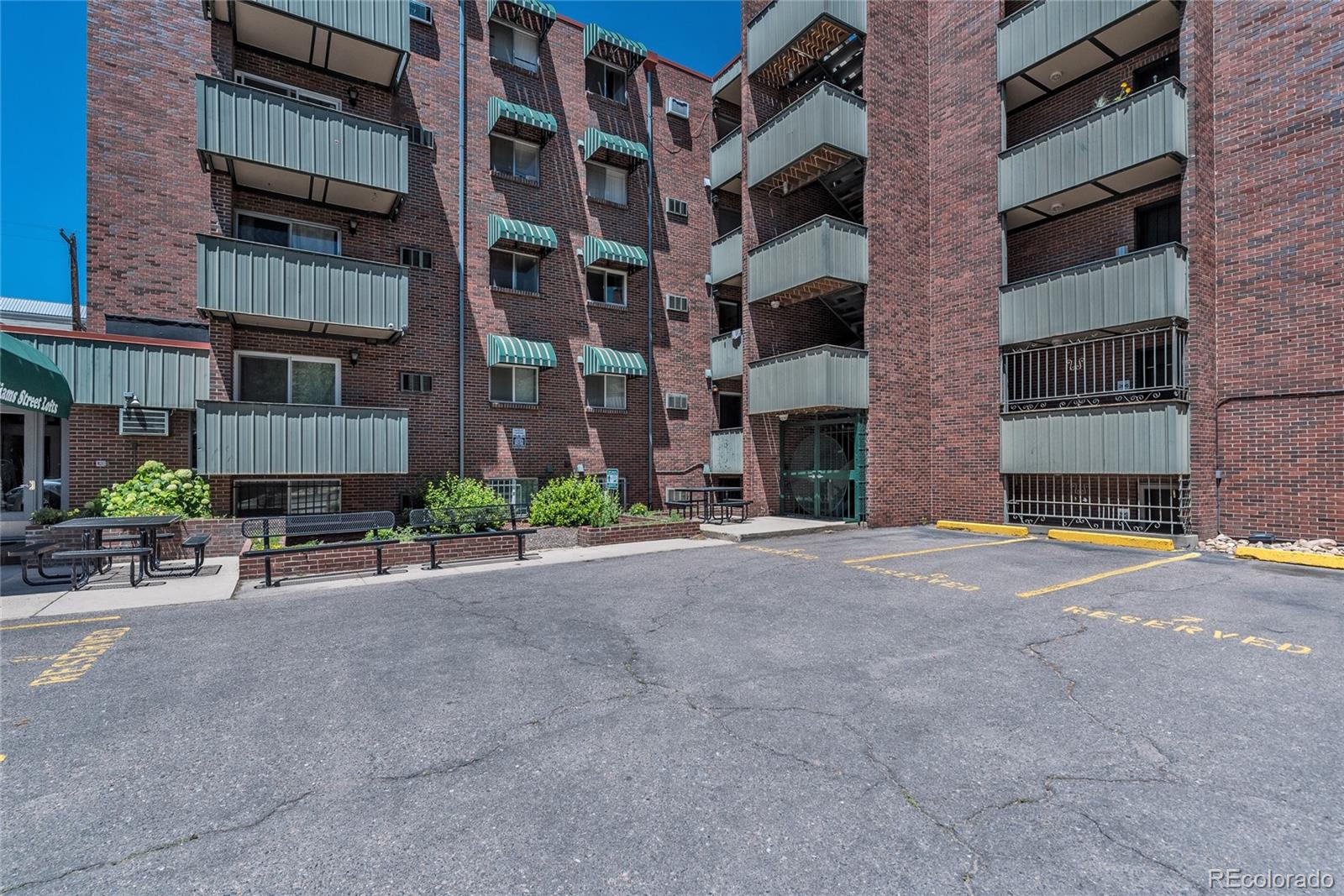 1833 North Williams Street, Unit 504 Denver, CO 80218 - Photo 18 of 19 a front view of a building with a yard and a garage