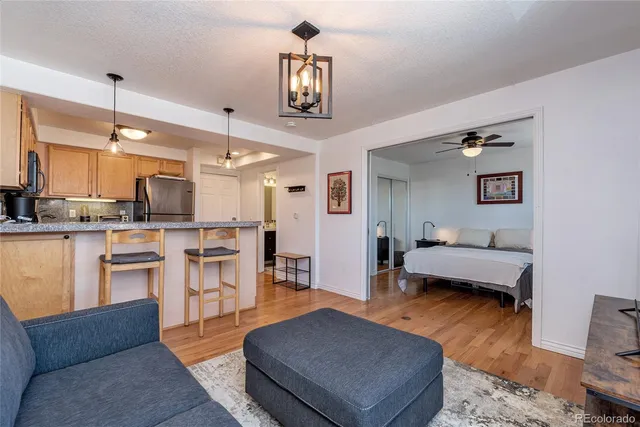 a living room with furniture and kitchen view