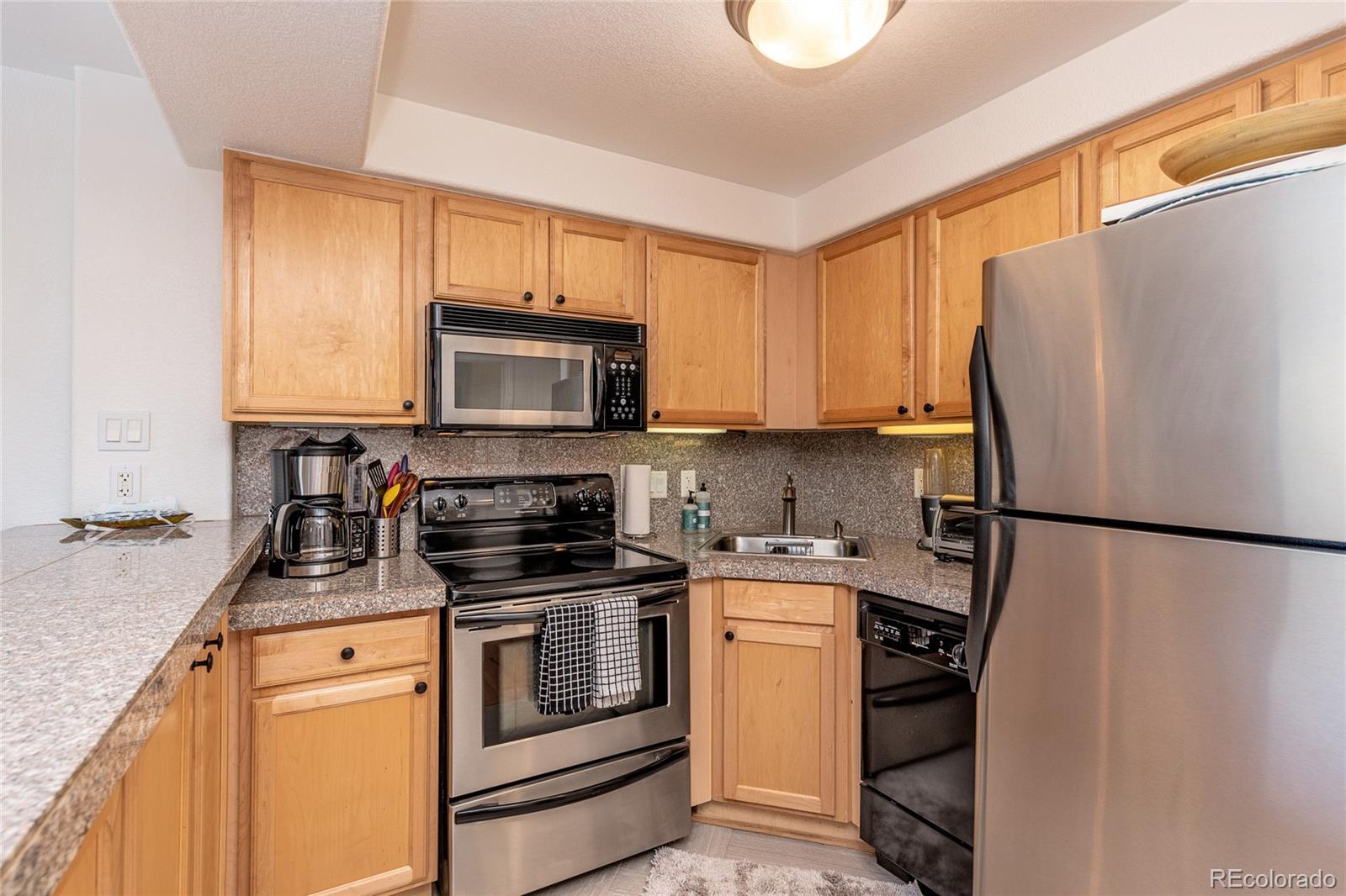 1833 North Williams Street, Unit 504 Denver, CO 80218 - Photo 5 of 19 a kitchen with a refrigerator sink and microwave