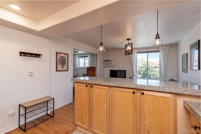 a large white kitchen with a large window