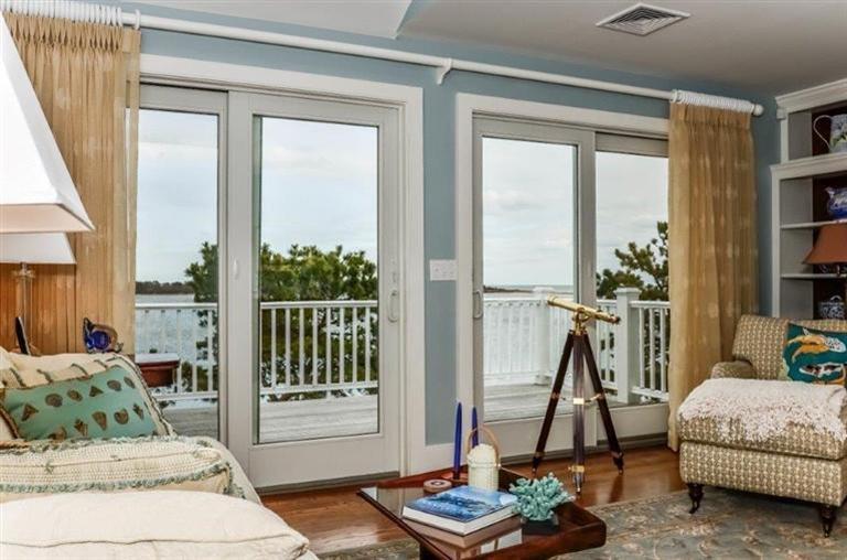 6 Yacht Club Road Falmouth, MA 02536 - Photo 11 of 35 a living room with furniture and a floor to ceiling window