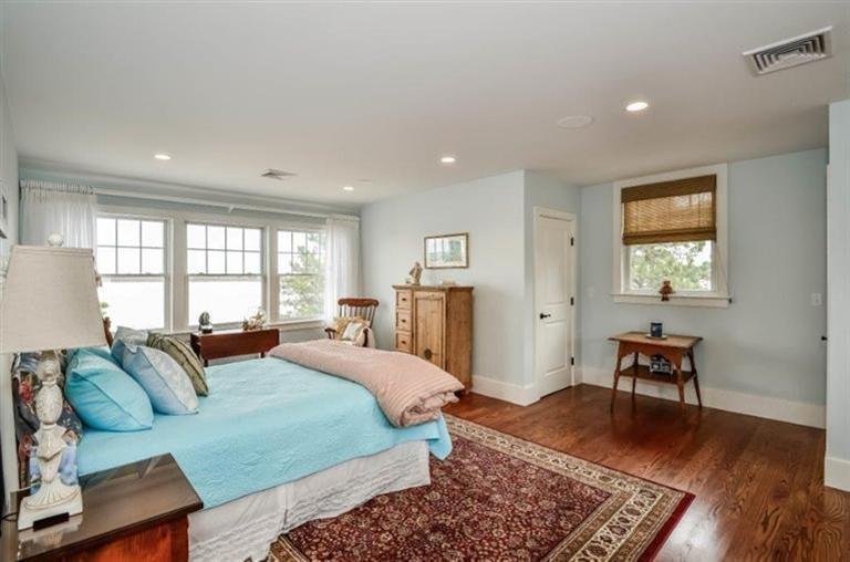 6 Yacht Club Road Falmouth, MA 02536 - Photo 23 of 35 a large bedroom with a bed and wooden floor