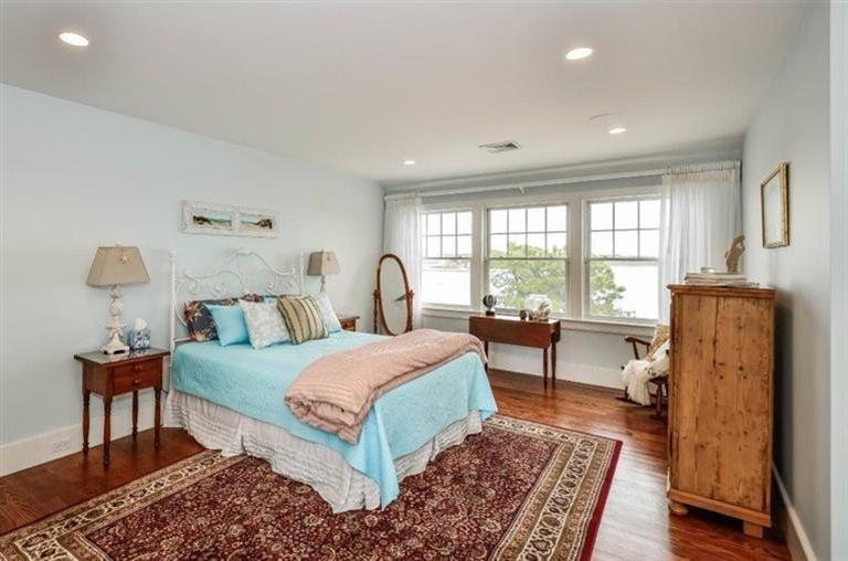 6 Yacht Club Road Falmouth, MA 02536 - Photo 24 of 35 a bedroom with a bed and wooden floor