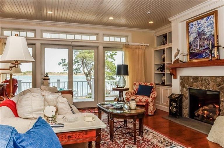 6 Yacht Club Road Falmouth, MA 02536 - Photo 5 of 35 a living room with furniture a fireplace and a large window