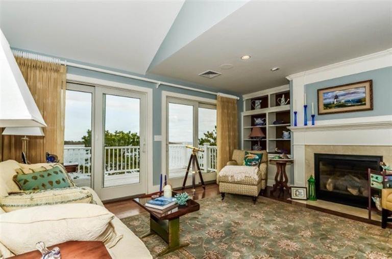 6 Yacht Club Road Falmouth, MA 02536 - Photo 10 of 35 a living room with furniture or fireplace and a floor to ceiling window
