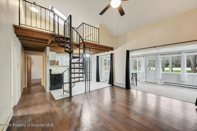 a view of entryway and hall with wooden floor