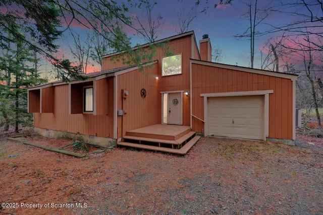 a backyard of a house with barbeque oven and brick wall