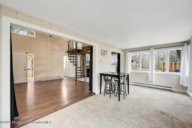 a view of a livingroom with furniture and a window