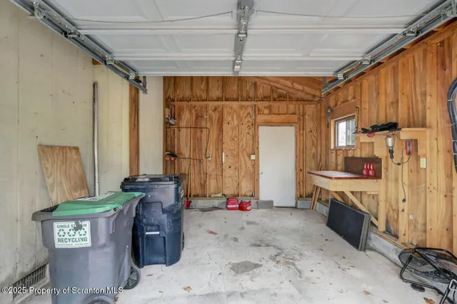 a backyard of a house with wooden deck and barbeque oven