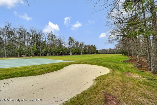 a view of balcony with wooden floor and fence