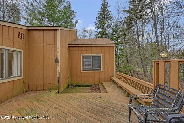 a view of a house with backyard and trees