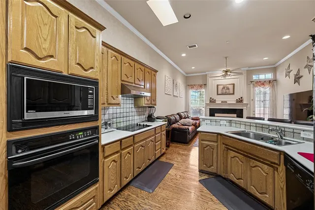 a kitchen with stainless steel appliances a stove microwave and cabinets