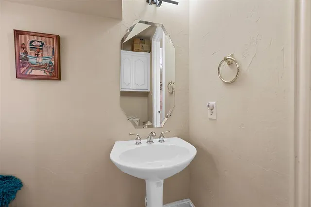 a bathroom with a sink and mirror