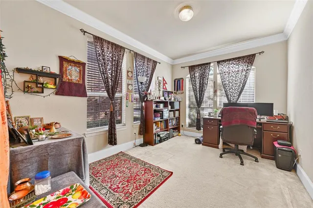 a view of a workspace with furniture and a window
