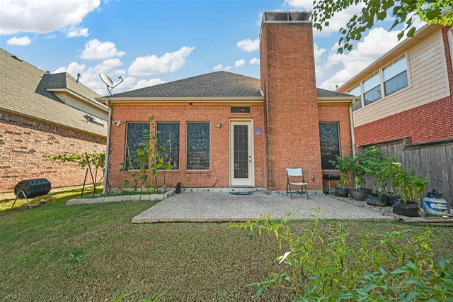 a view of a house with a yard and sitting area