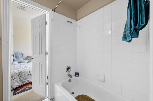 a bathroom with a bathtub and shower